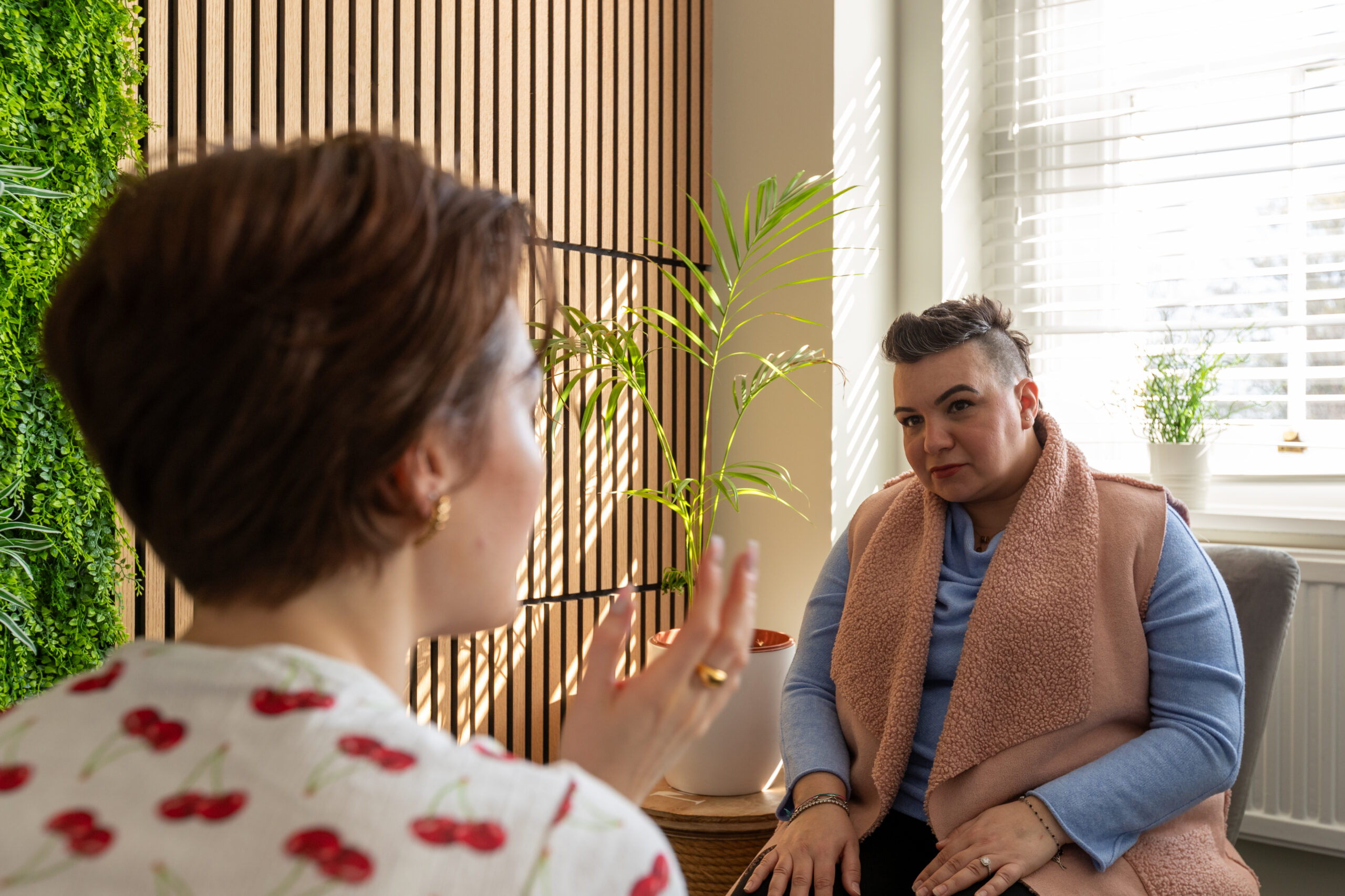 Rossella Todde in a counselling session, listening attentively to a client